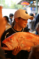 Kid holding a fish.